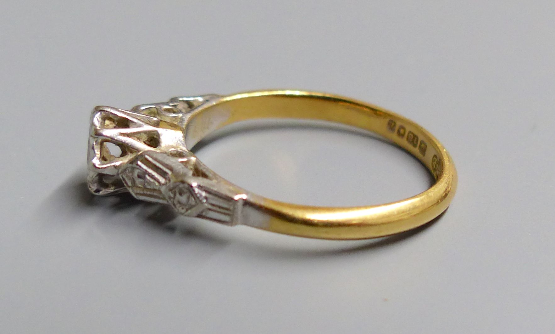 A 1960s 18ct gold and illusion set solitaire diamond ring, size J/K, gross 2.4 grams.